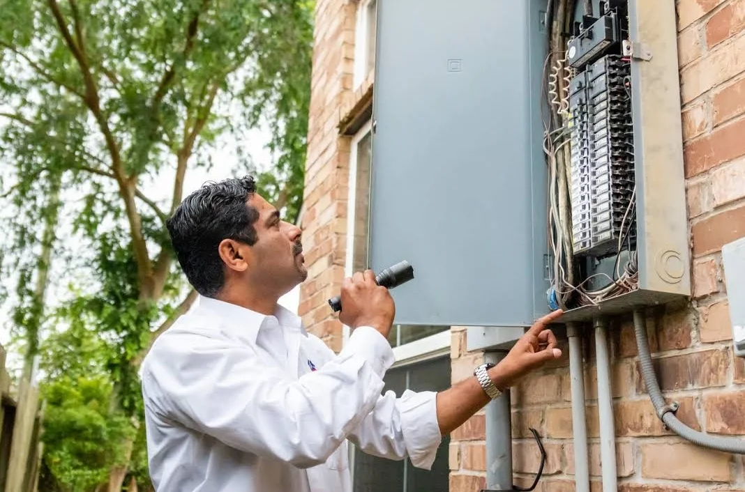 Alex Mathew inspecting an electrical panel