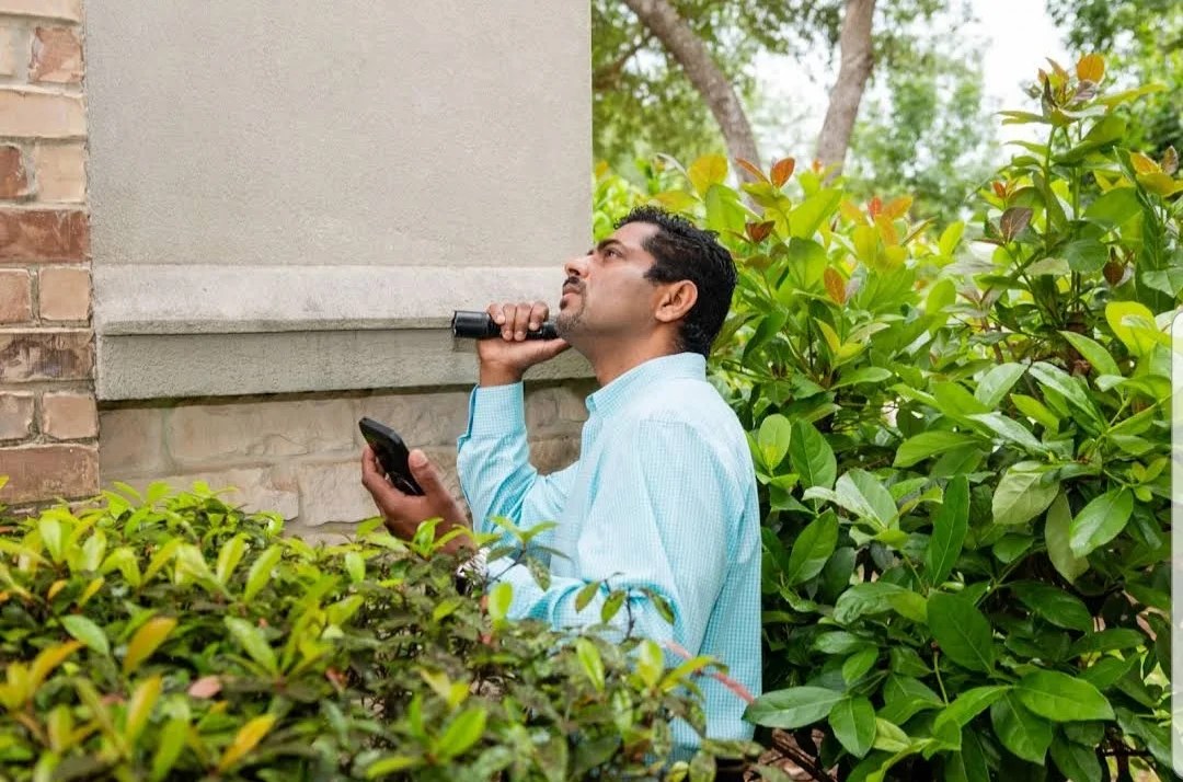 Alex Mathew checking a home exterior during an inspection